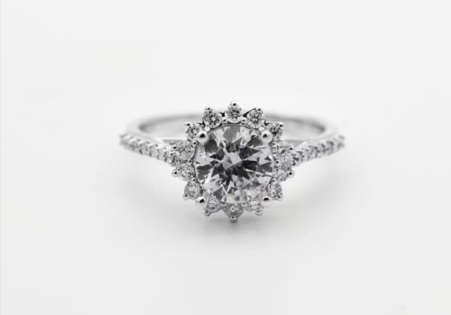 Diamond halo engagement ring; fine jewelry sales and repair services.