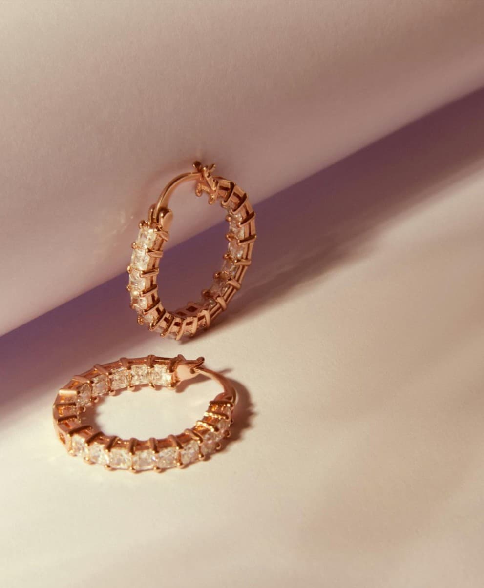 Rose gold hoop earrings with cubic zirconia; jewelry sale item.