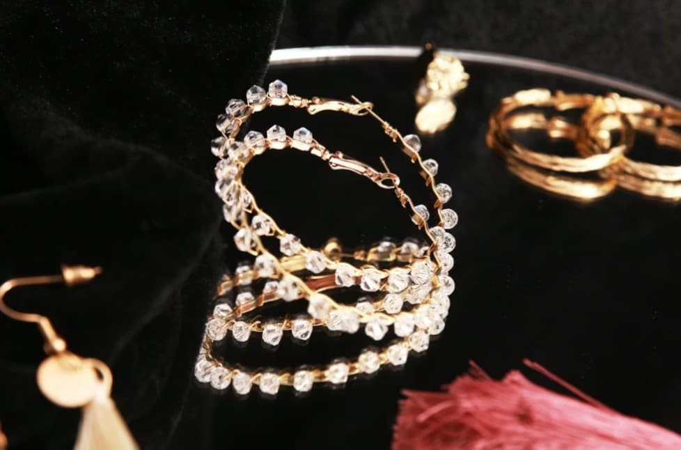 Gold hoop earrings with crystal beads; fashion jewelry sales and repair.