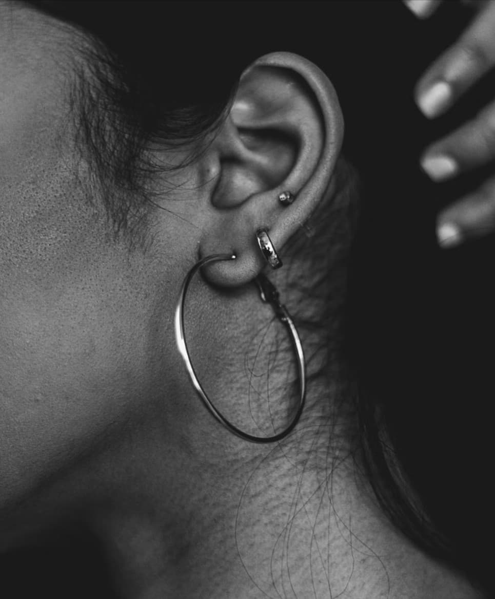 Ear with hoop earring and piercings. Jewelry repair services.