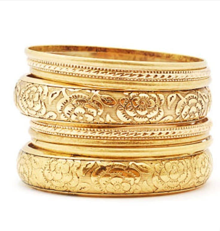 Gold bangle bracelets with floral engraving for jewelry repair or sales.
