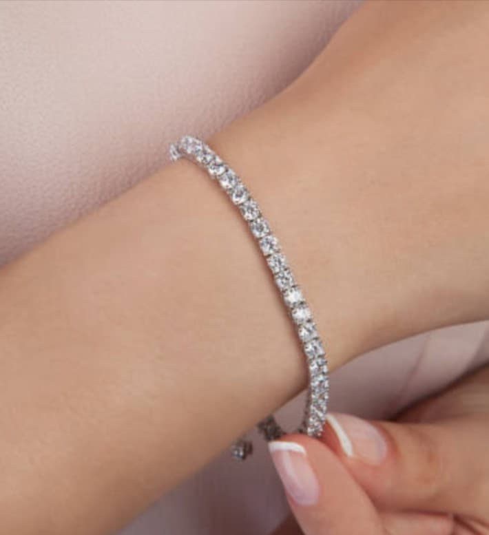 Diamond tennis bracelet on wrist; jewelry sales and bracelet repair.