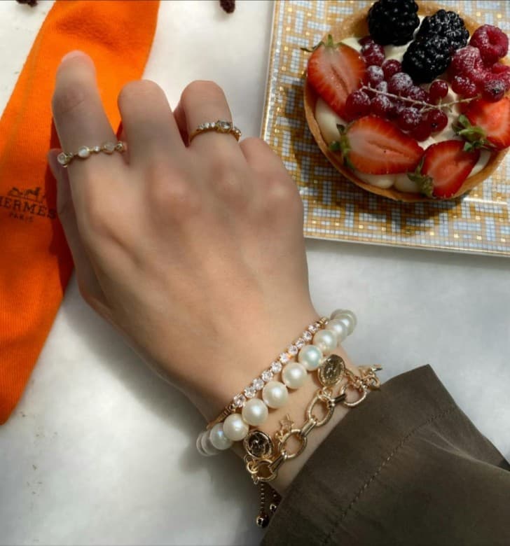 Pearl bracelet stack and gemstone rings; jewelry repair available.