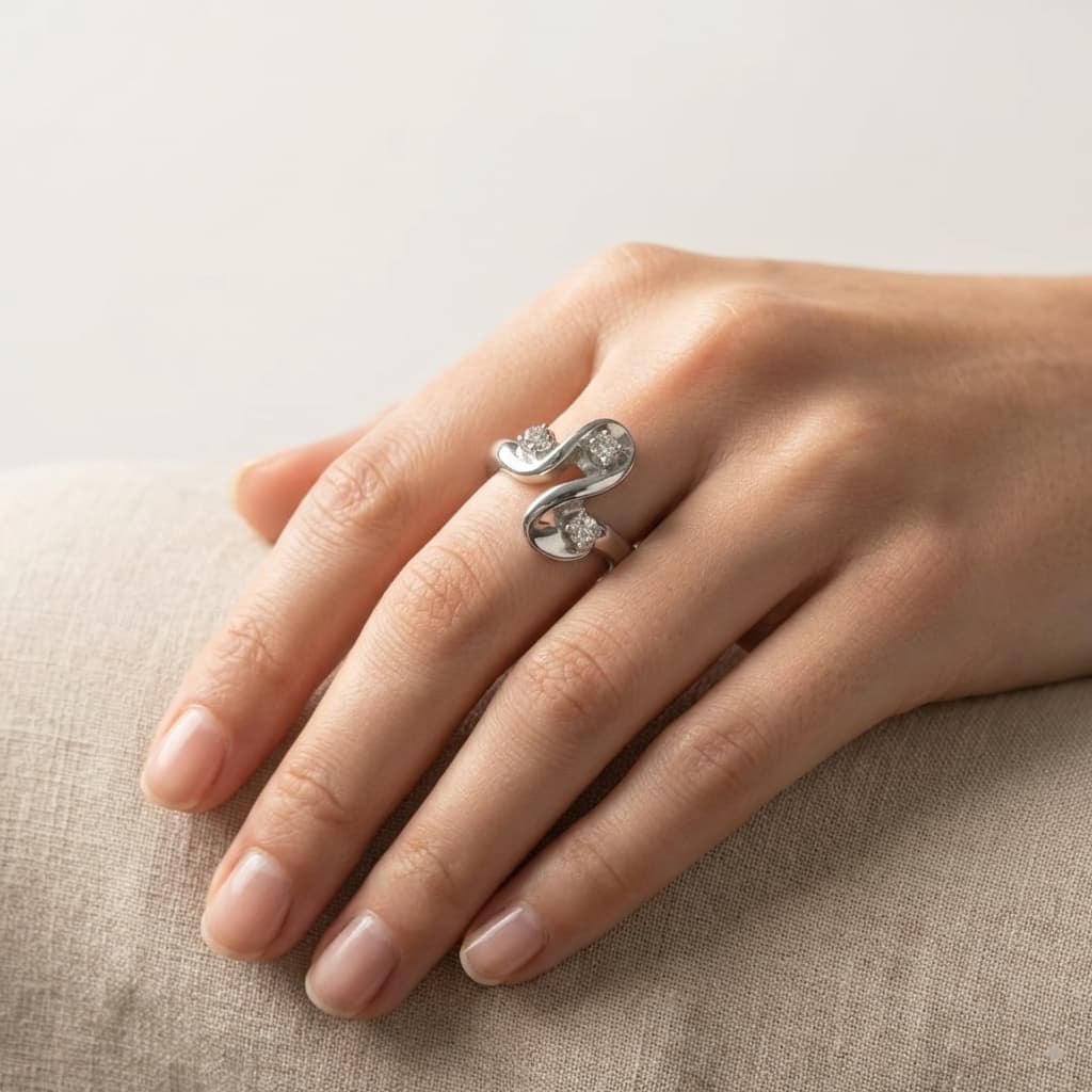 Hand wearing a modern diamond ring, jewelry sales and repair.